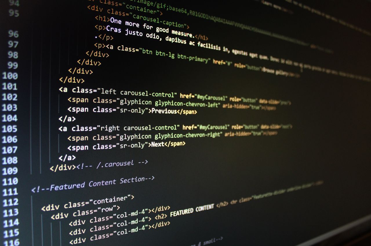 Close-up of HTML code displayed on a computer monitor, showcasing web development.
